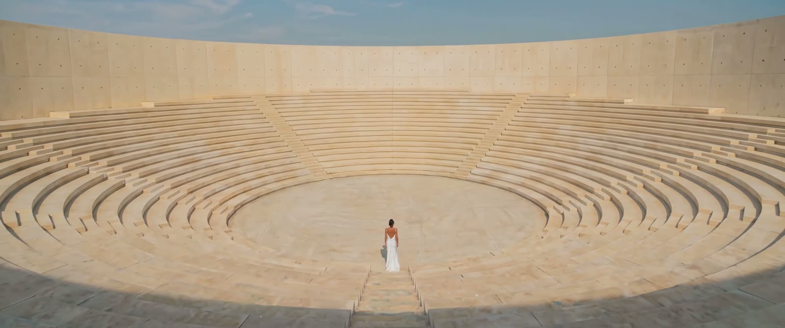 Still from I Am the Sound — an amphitheater of pale stone